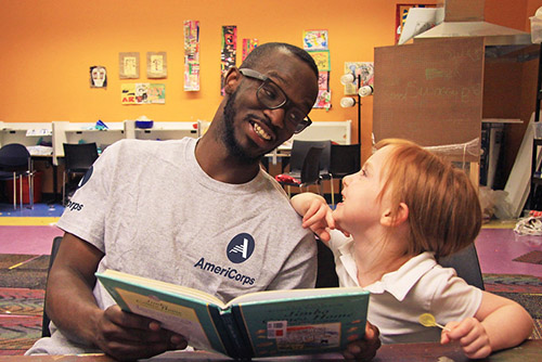 AmeriCorps member reading